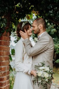 Brautpaar küsst sich Bräutigam hält Wange der Braut